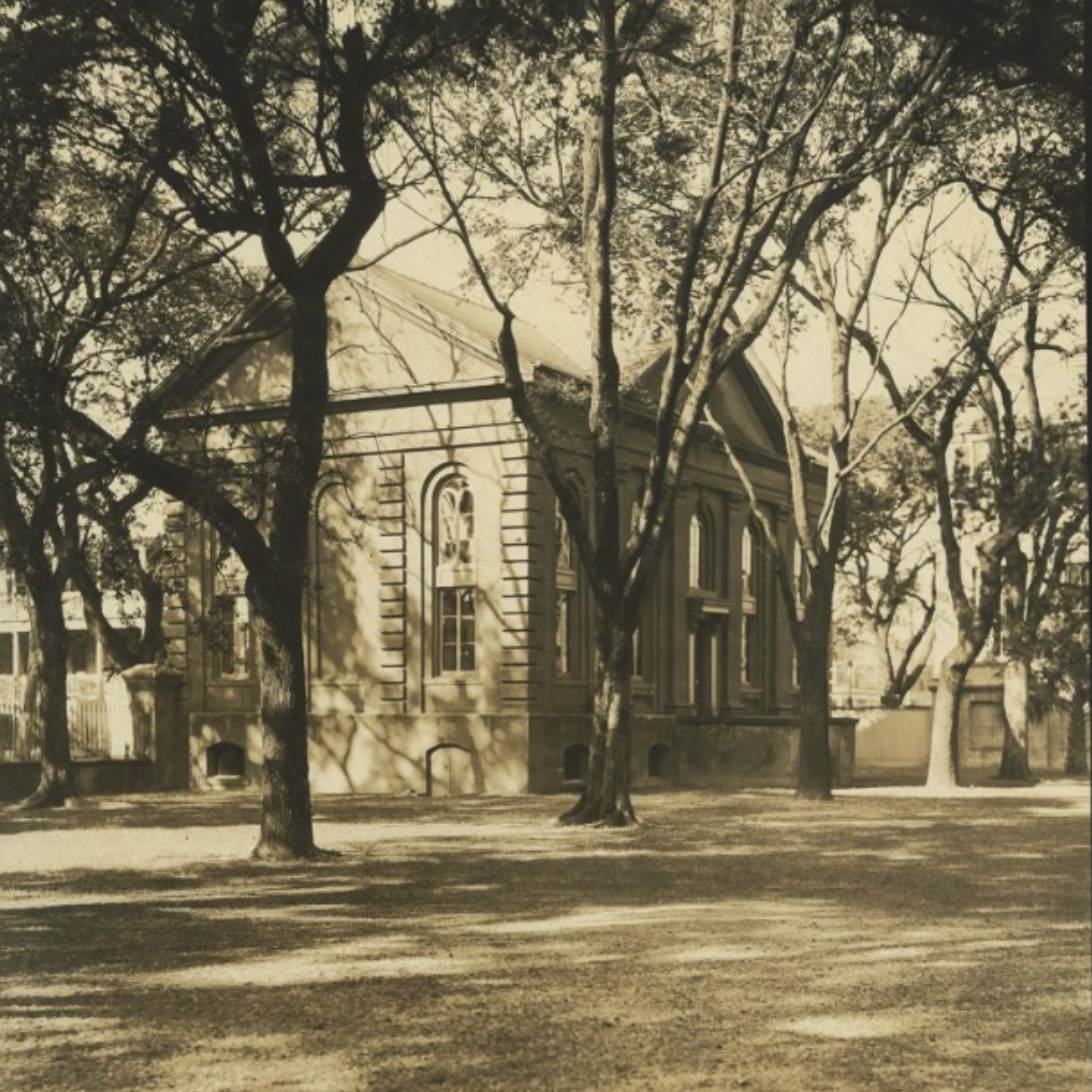 An old photo of a building (Towell Library) with trees nearby